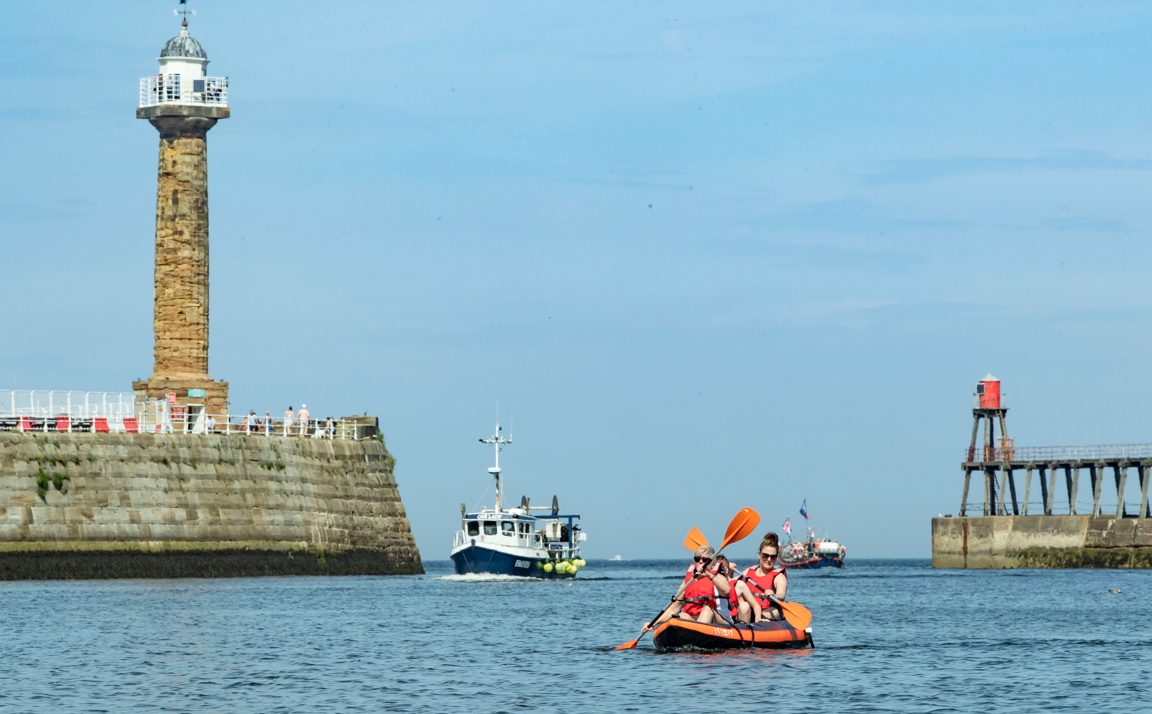 People boat in the harbour at Whitby in Yorkshire, as a bank holiday heatwave will see most of the country sizzling in sunshine with possible record temperatures, the Met Office has said.
