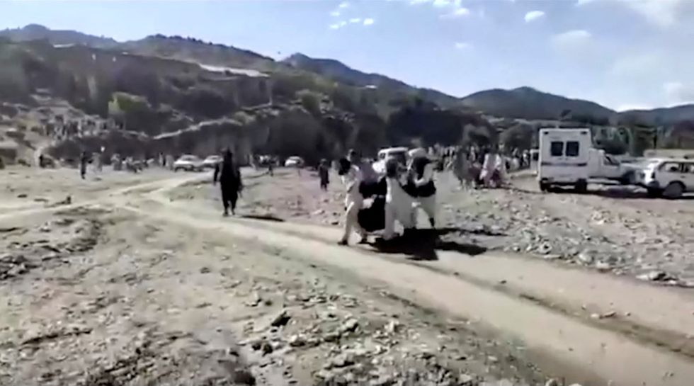 People carry injured to be evacuated following a massive earthquake, in Paktika Province, Afghanistan, June 22, 2022, in this screen grab taken from a video. BAKHTAR NEWS AGENCY/Handout via REUTERS THIS IMAGE HAS BEEN SUPPLIED BY A THIRD PARTY