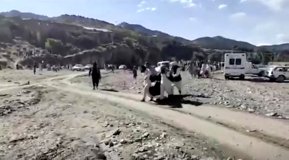 People carry injured to be evacuated following a massive earthquake, in Paktika Province, Afghanistan, June 22, 2022, in this screen grab taken from a video. BAKHTAR NEWS AGENCY/Handout via REUTERS    THIS IMAGE HAS BEEN SUPPLIED BY A THIRD PARTY