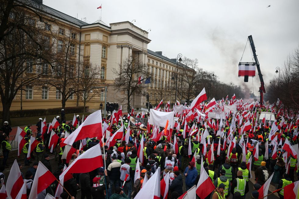 People carry Polish flags and banners during protest
