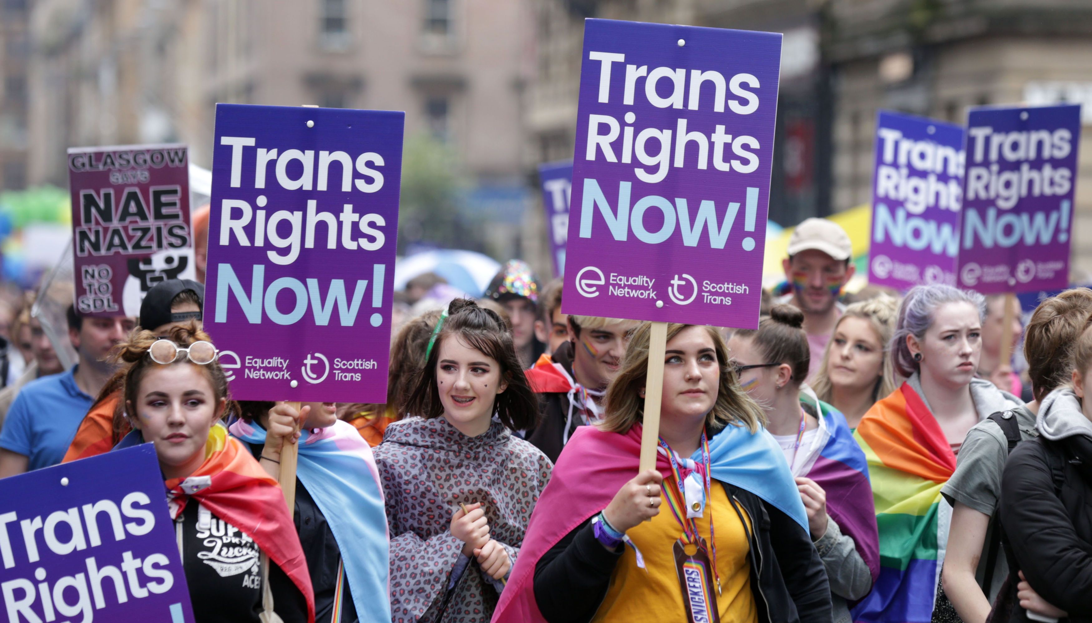 People carry Trans rights banners in the Pride Glasgow parade.