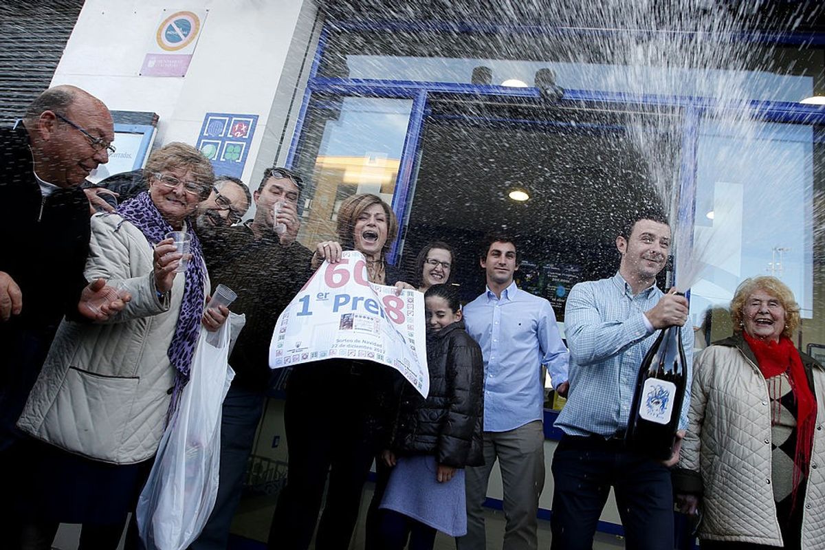 People celebrate after winning the first prize of Spain's Christmas lottery named "El Gordo" (Fat One) in Granen, in Manise, near Valencia, on December 22, 2012