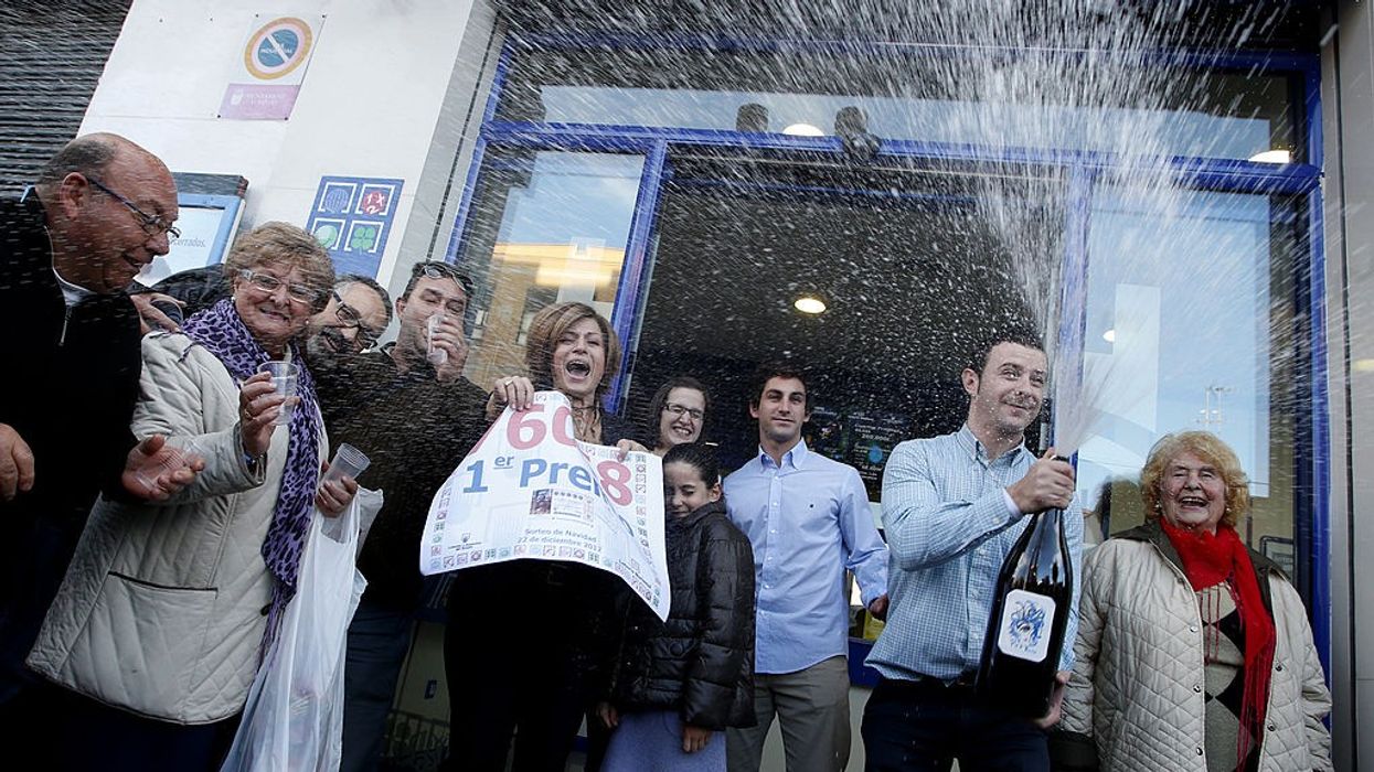 People celebrate after winning the first prize of Spain's Christmas lottery named "El Gordo" (Fat One) in Granen, in Manise, near Valencia, on December 22, 2012