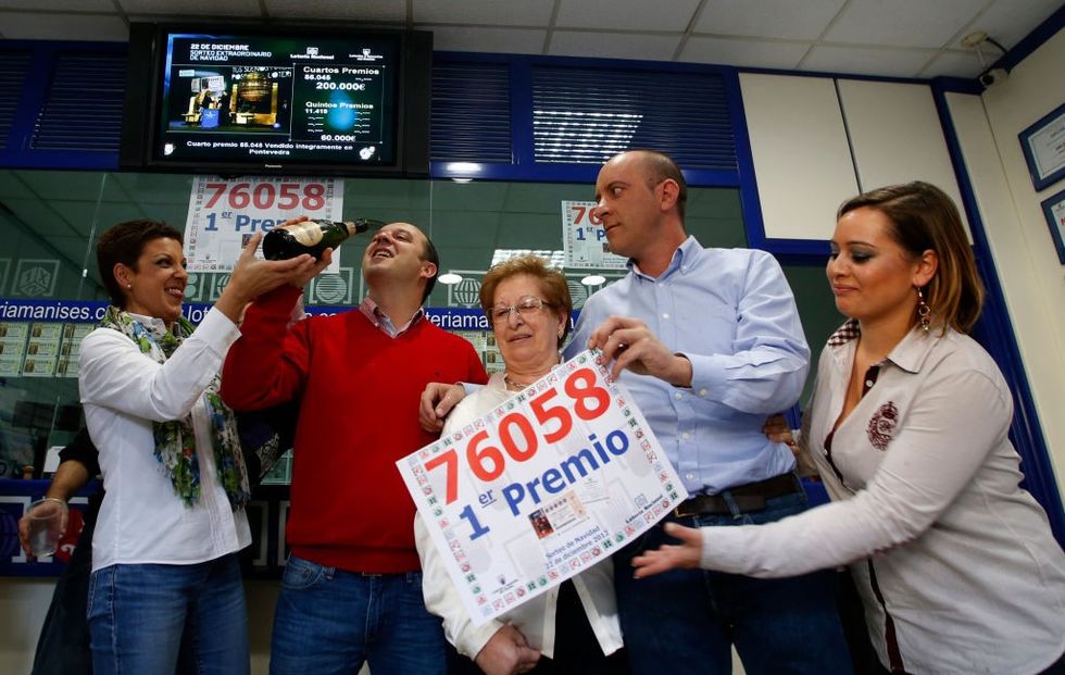 People celebrate after winning the first prize of Spain's Christmas lottery named "El Gordo" (Fat One) in Granen, in Manise, near Valencia, on December 22, 2012
