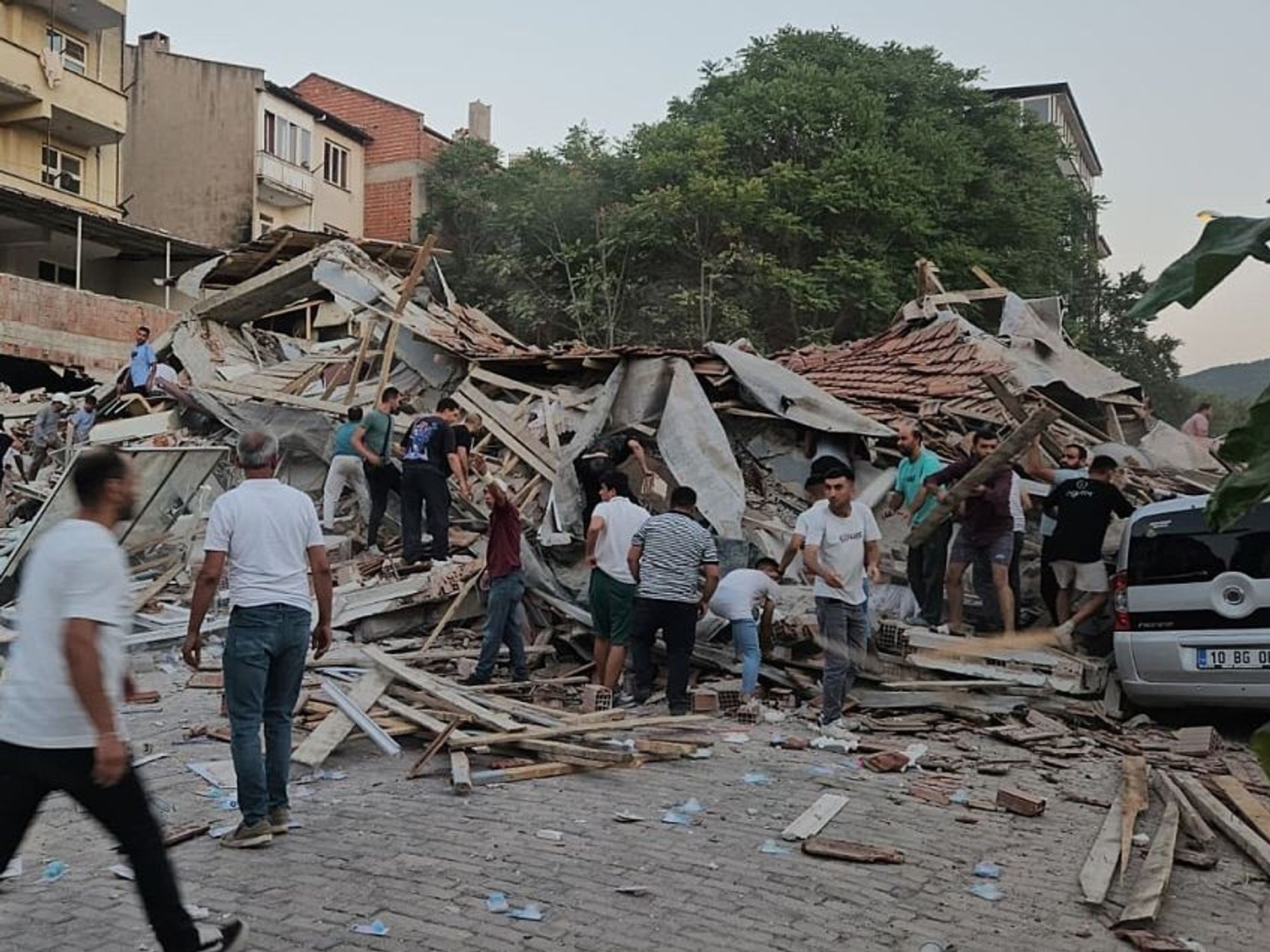 People conduct search and rescue operation after a 6.1-magnitude earthquake struck with its epicenter in the Sindirgi district of Balikesir,