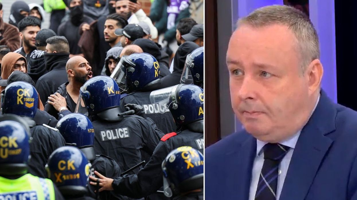 People confront police officers during a protest in Bolton and Mark White