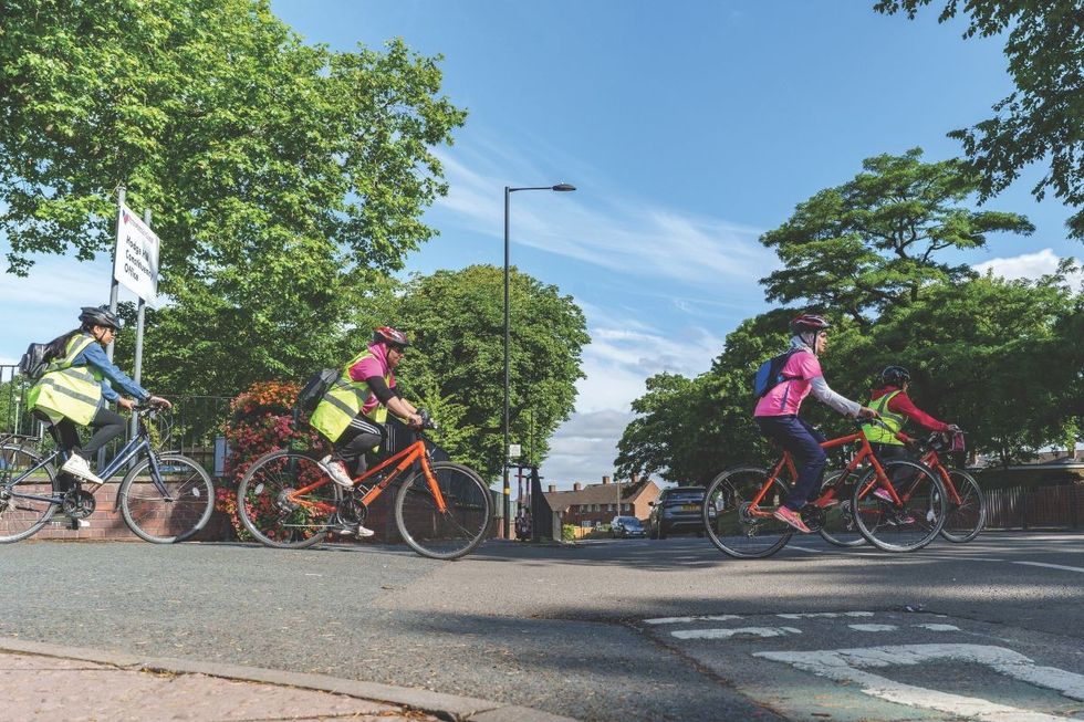 People cycling across a road