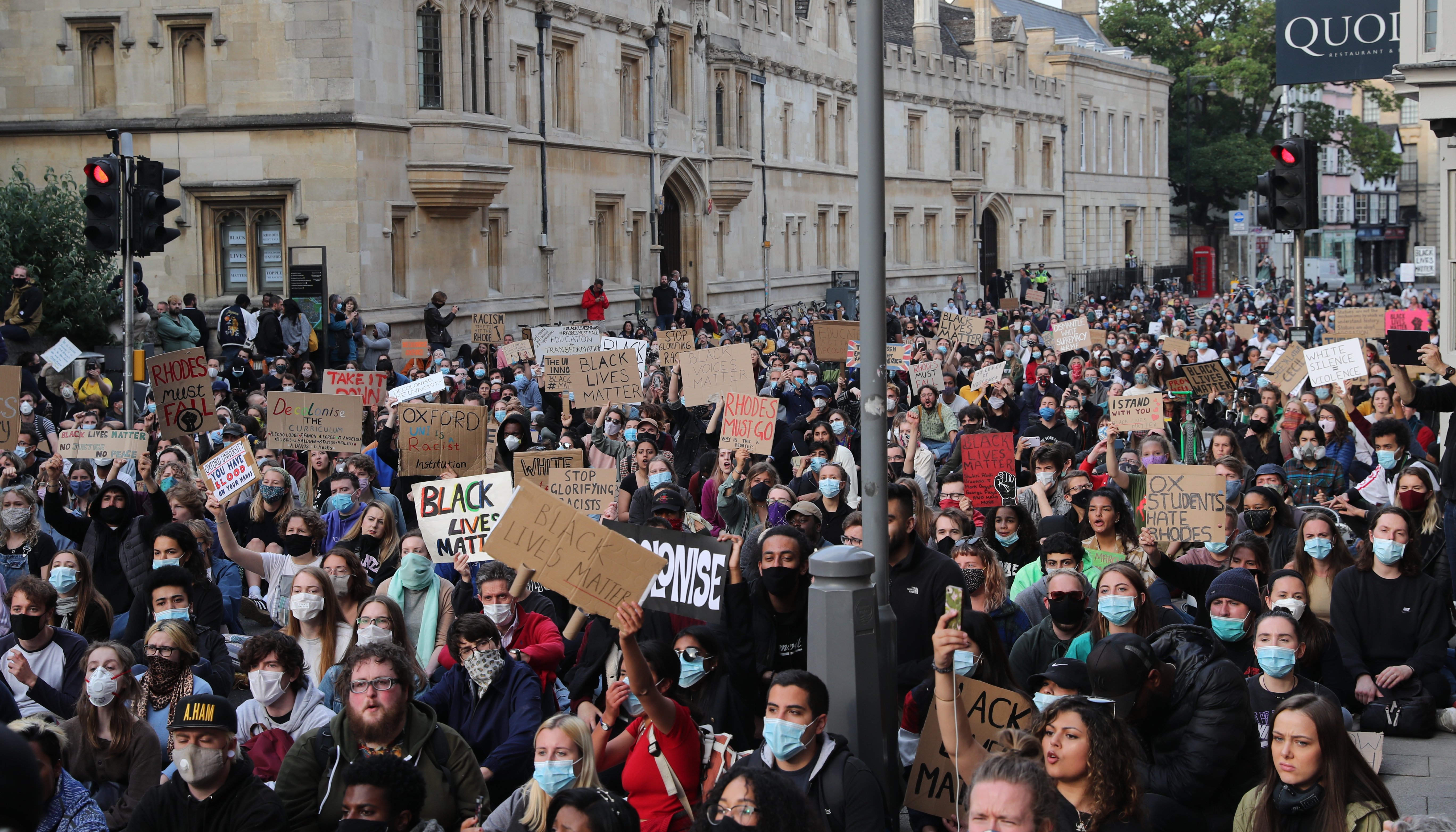 People during a protest calling for the removal of the statue of 19th century imperialist, politician Cecil Rhodes from an Oxford college which has reignited amid anti-racism demonstrations.