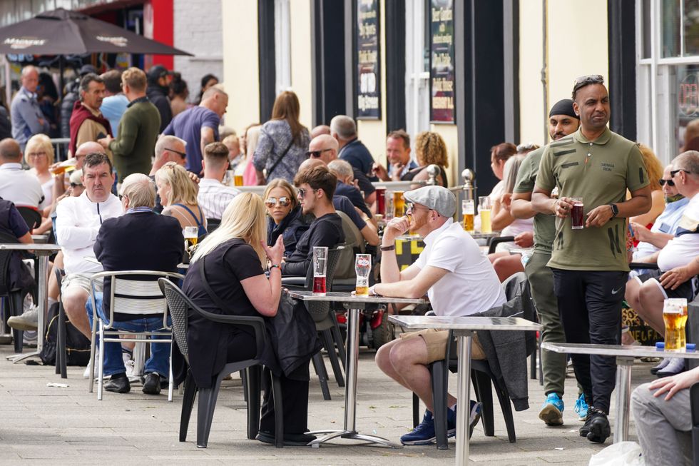 People enjoy a drink at a pub along the seafront in Southend.
