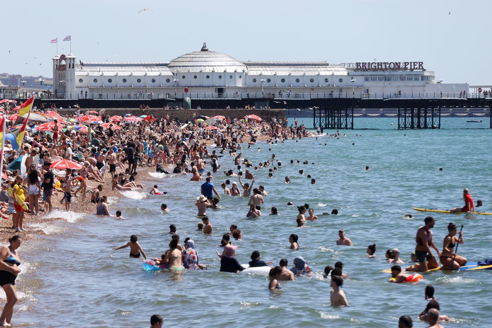 People enjoy a swim in the sea on Brighton coast as the heatwave continues