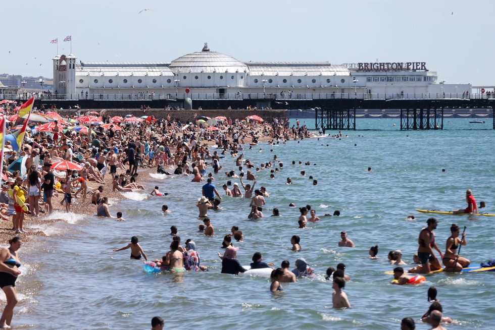 People enjoy a swim in the sea on Brighton coast