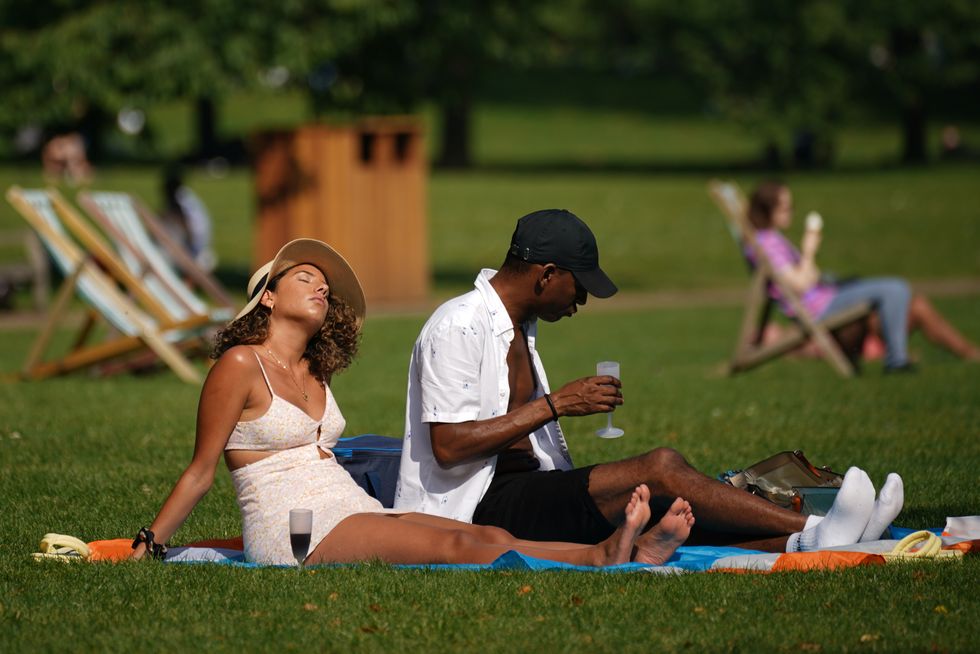 People enjoy the sun in St James's Park, London. Parts of the UK could see an official heatwave in the coming days, with temperatures hitting almost 30C (86F), forecasters have said. Picture date: Sunday September 5, 2021.