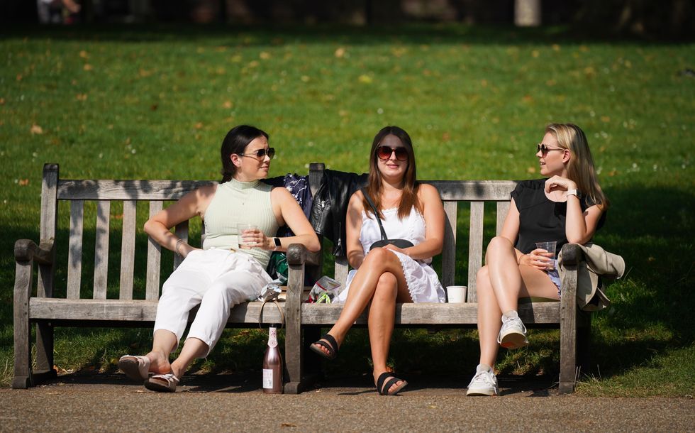 People enjoy the sun in St James's Park, London
