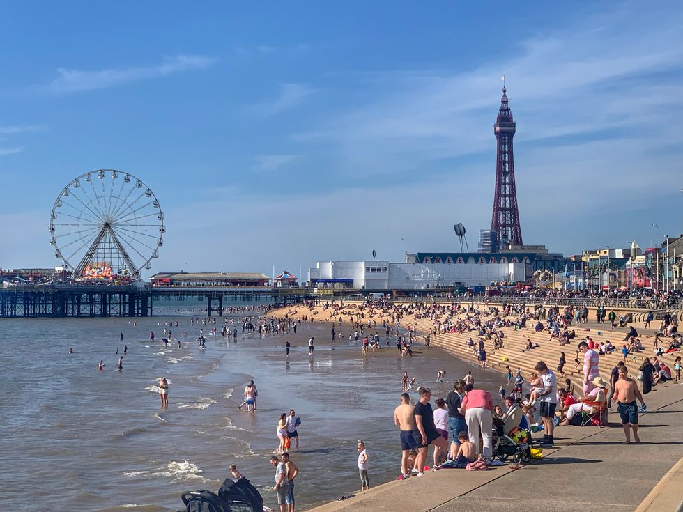 People enjoy the sunshine at Blackpool beach, as Bank Holiday Monday could be the hottest day of the year so far - with temperatures predicted to hit 25C in parts of the UK. Picture date: Monday May 31, 2021.