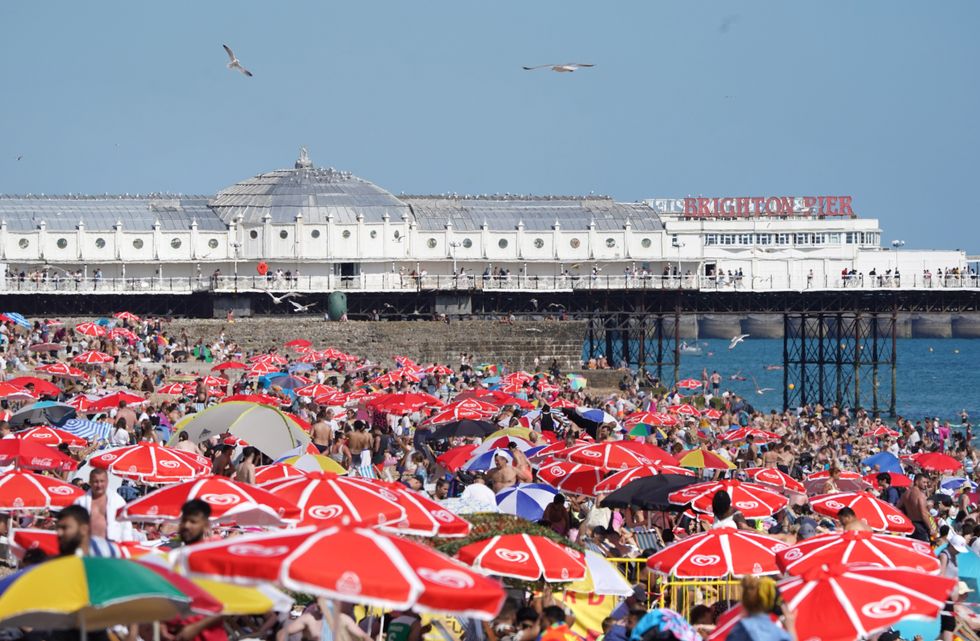 People enjoy the warm weather at Brighton beach in West Sussex