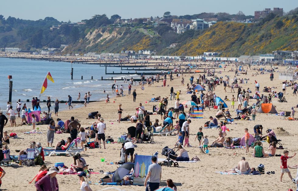 People enjoy the warm weather on Bournemouth beach. Good Friday is set to be the hottest day of the year so far, experts have predicted, ahead of %22very pleasant%22 spring conditions over the Easter weekend. Picture date: Friday April 15, 2022.