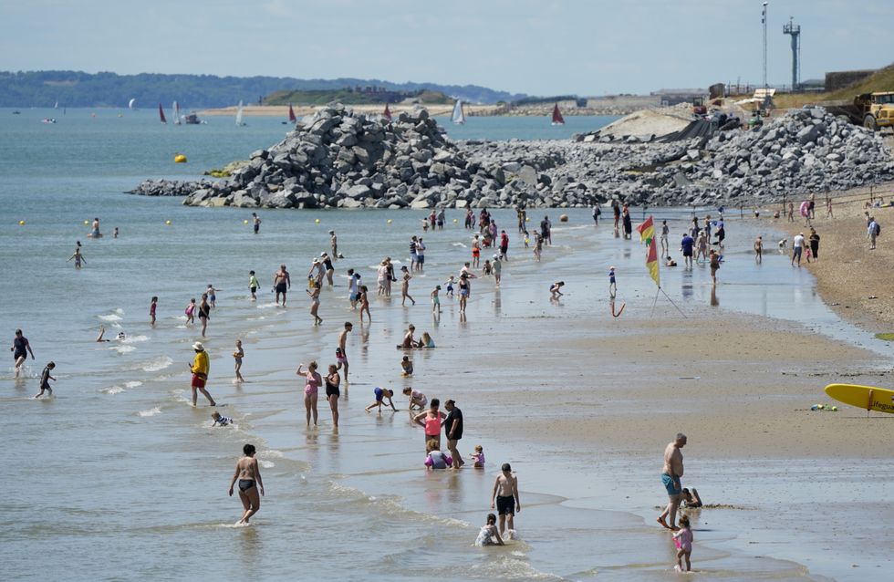 People enjoy the warm weather on Southsea Beach in Hampshire. Picture date: Saturday July 9, 2022.