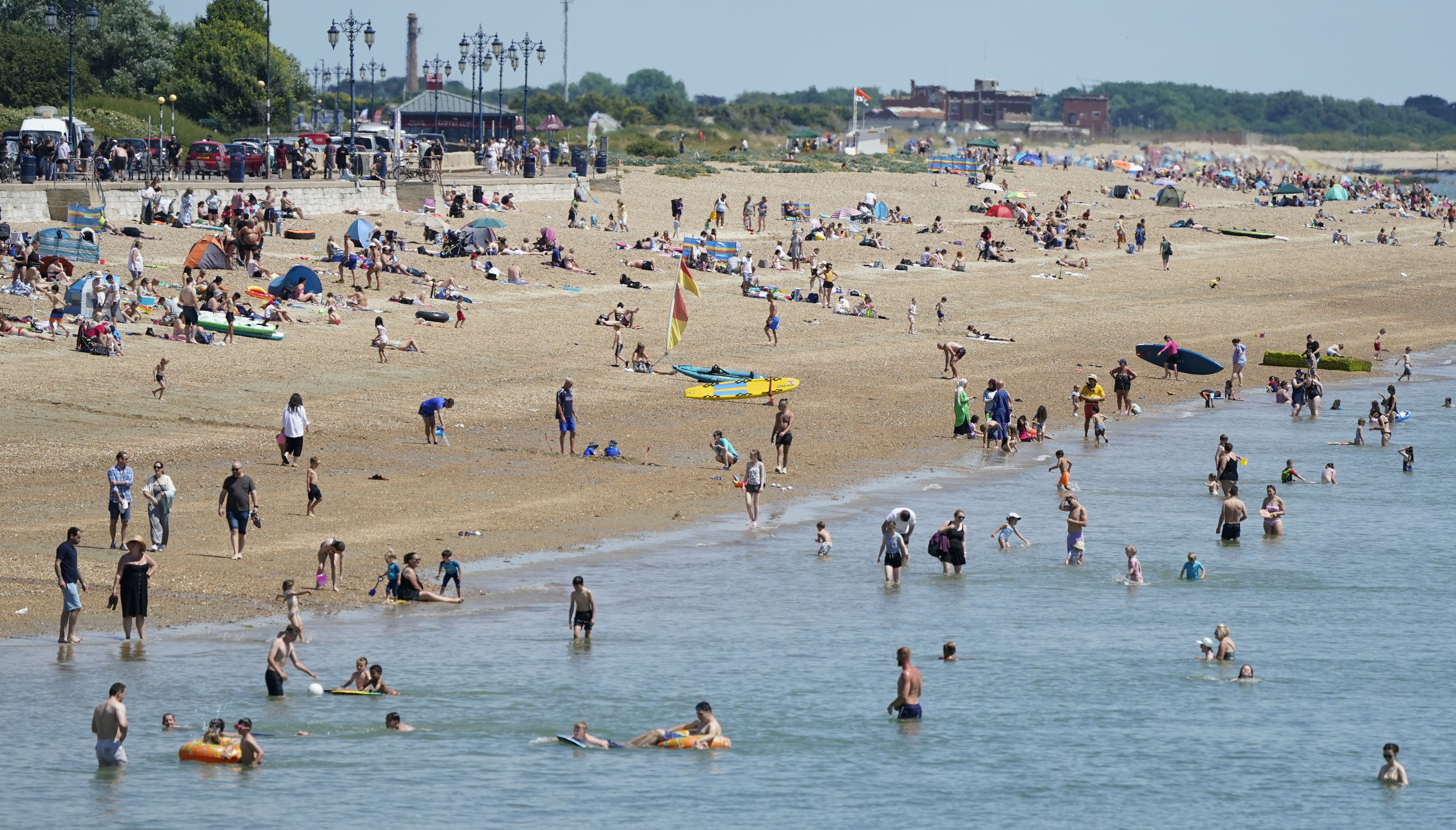 People enjoy the warm weather on Southsea Beach in Hampshire.