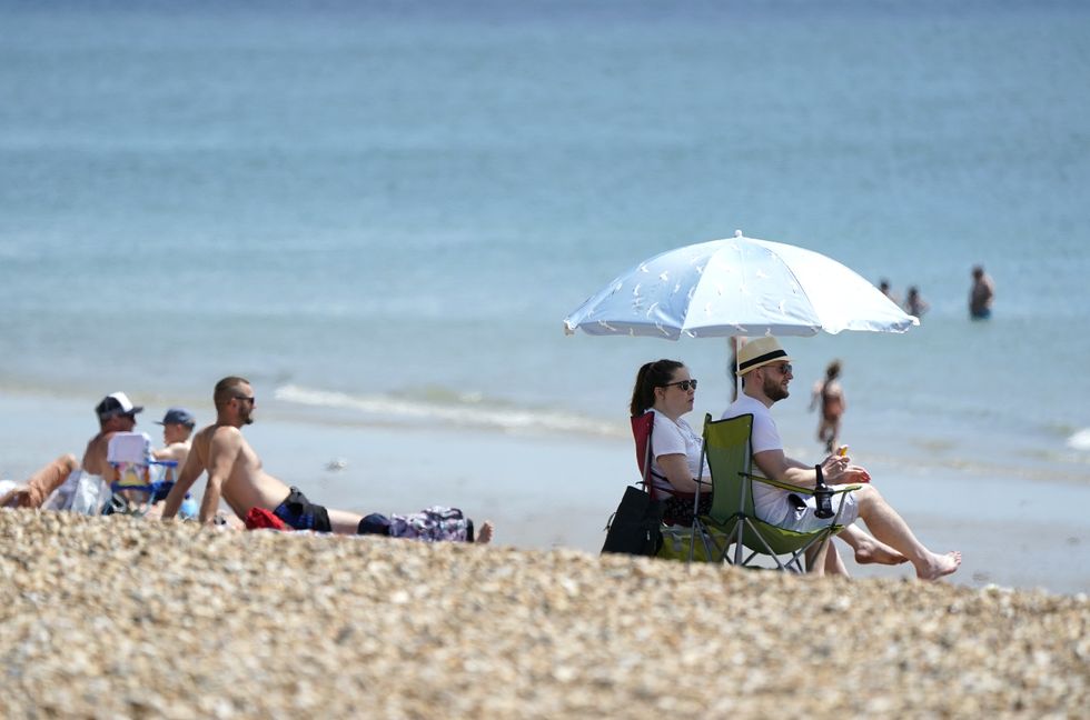 People enjoy the warm weather on Southsea Beach in Hampshire