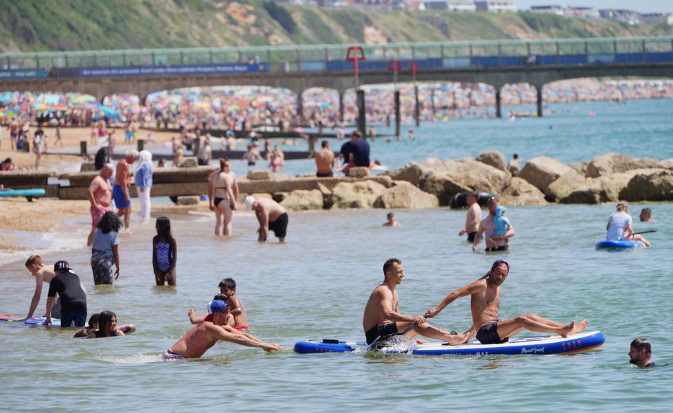 People enjoy the weather on Bournemouth beach in Dorset. England could see the hottest day of the year this weekend as the skies finally clear after weeks of wet and humid weather. Picture date: Saturday July 17, 2021.
