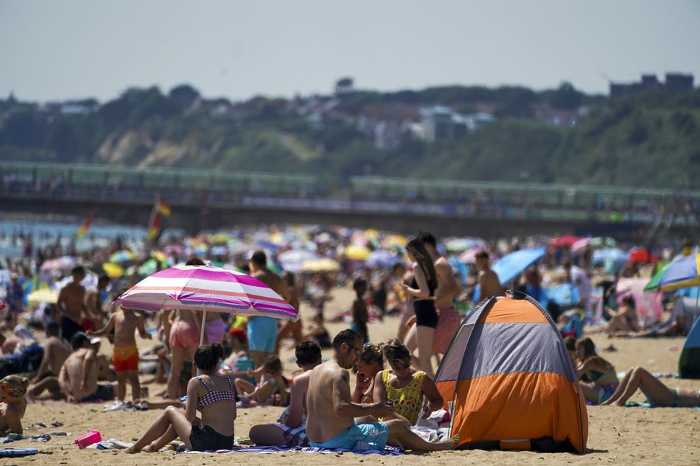 People enjoy the weather on Bournemouth beach in Dorset. Picture date: Monday July 19, 2021.