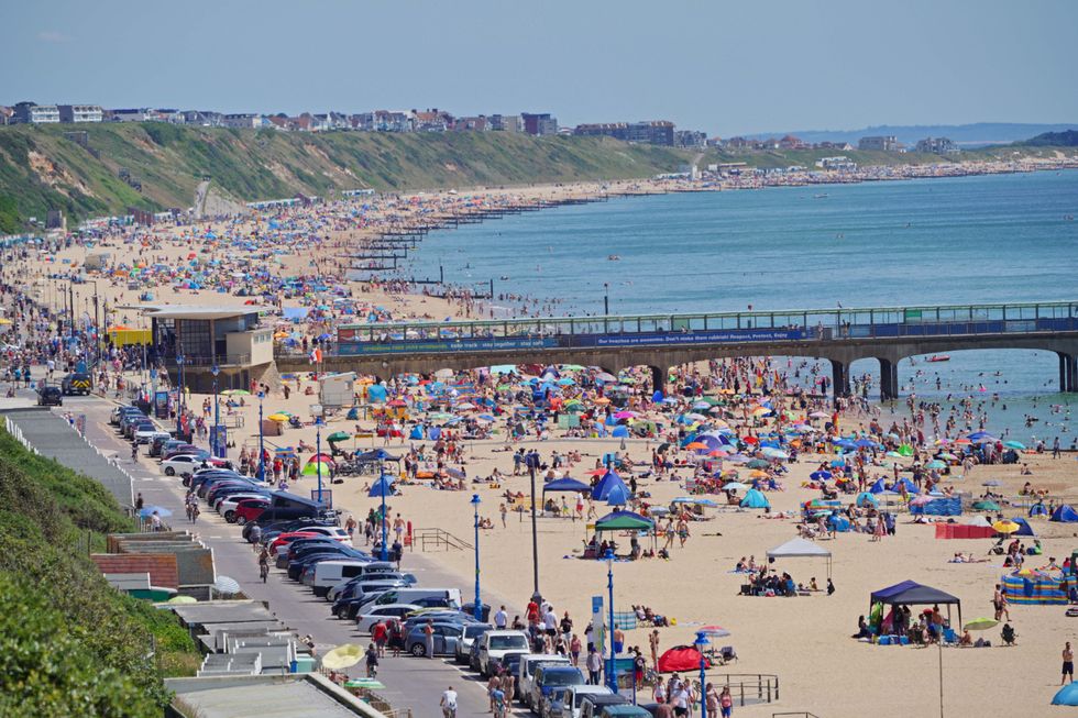 People enjoy the weather on Bournemouth beach in Dorset.