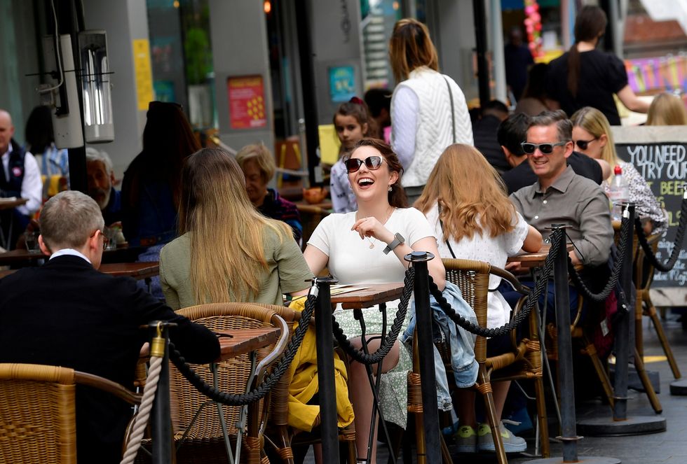 People enjoying a drink at a bar in London