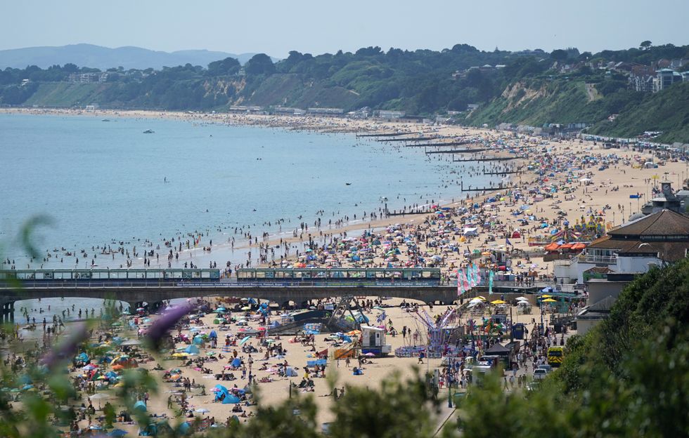 People enjoying the hot weather at Bournemouth Beach in Dorset.