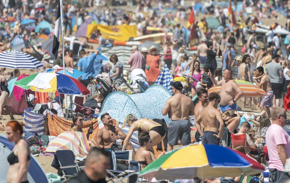 People enjoying the warm weather on Scarborough beach, North Yorkshire. Picture date: Sunday July 10, 2022.