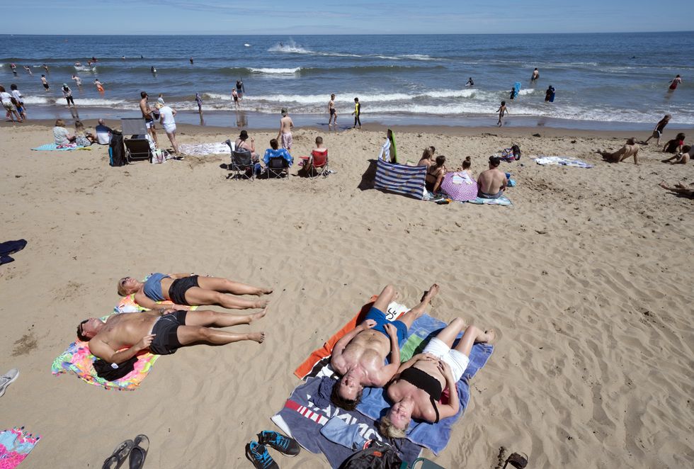 People enjoying the warm weather on Scarborough beach, North Yorkshire.