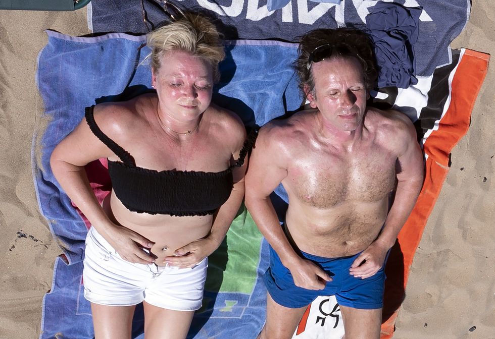 People enjoying the warm weather on Scarborough beach, North Yorkshire.