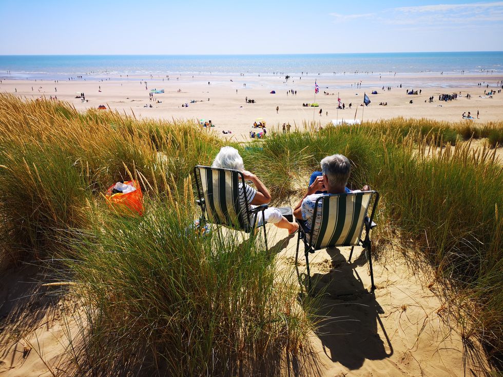 People enjoying warm weather on a beach