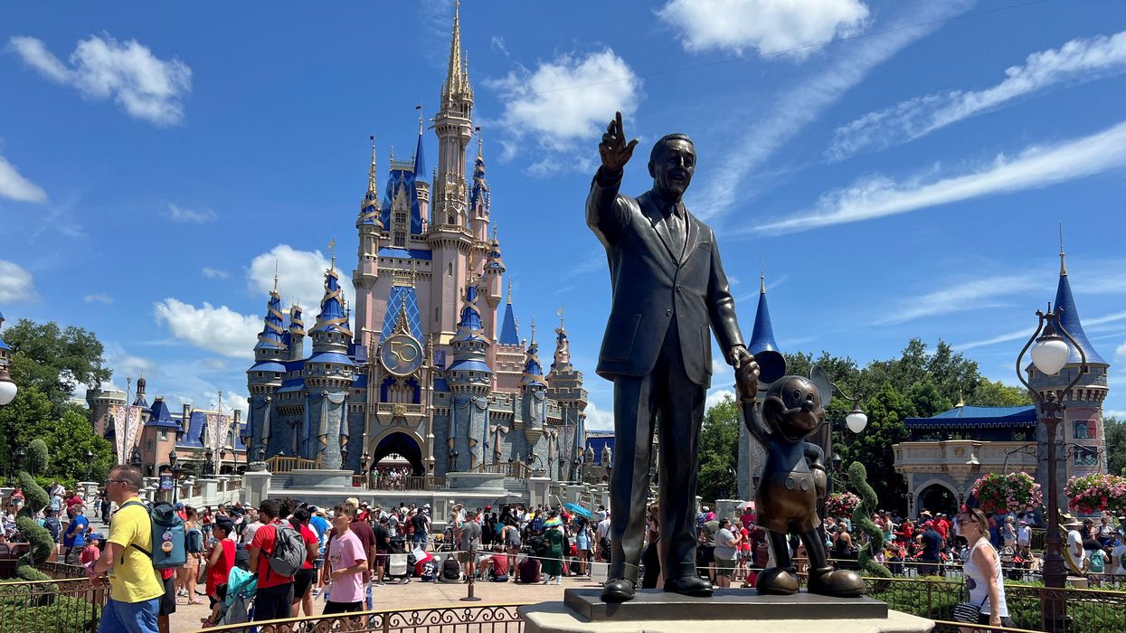 People gather at the Magic Kingdom theme park before the "Festival of Fantasy" parade at Walt Disney World in Orlando