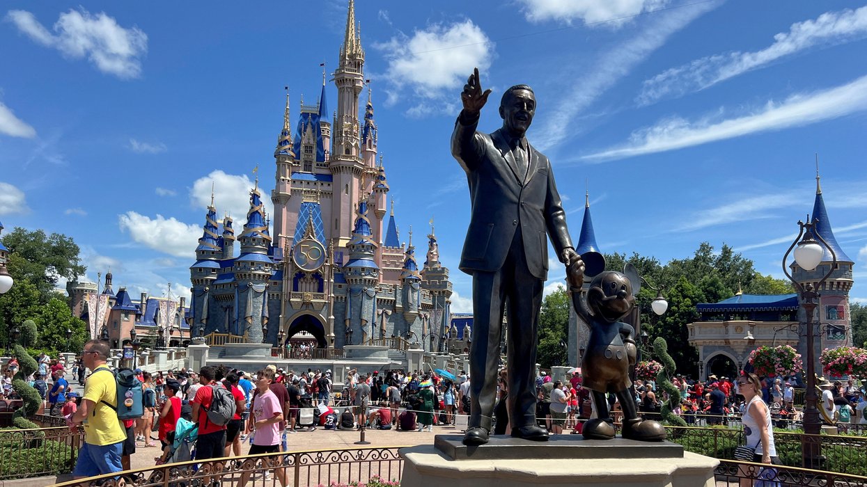People gather at the Magic Kingdom theme park before the "Festival of Fantasy" parade at Walt Disney World in Orlando