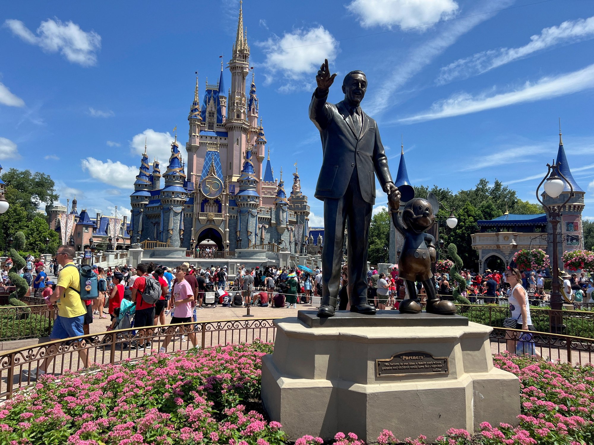 People gather at the Magic Kingdom theme park before the "Festival of Fantasy" parade at Walt Disney World in Orlando