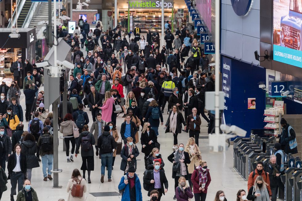 People in a station wearing masks