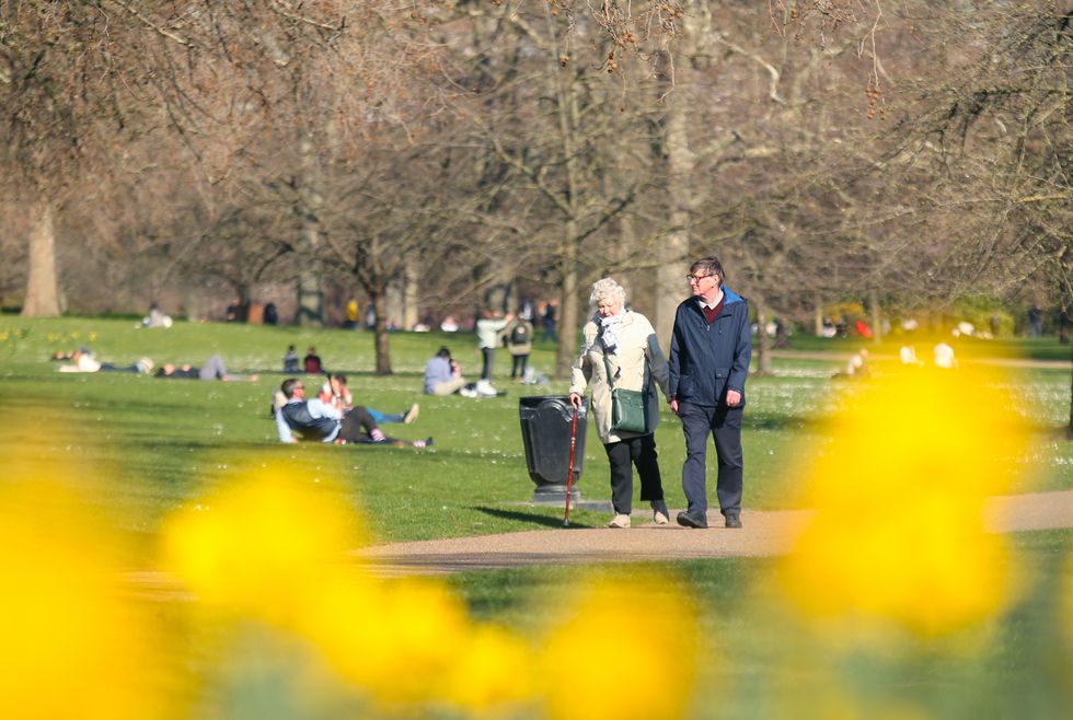 People in St James' Park, central London, as the UK see's the first glimpse of spring weather. Picture date: Friday March 18, 2022.