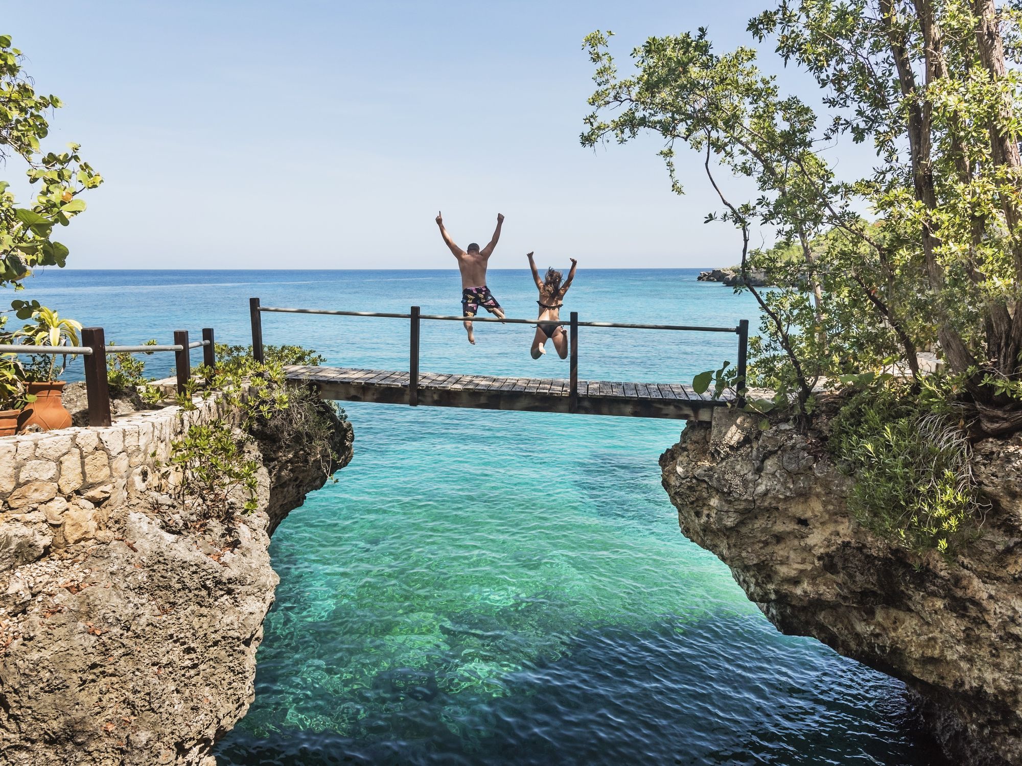 People jumping off bridge in Negril, Jamaica