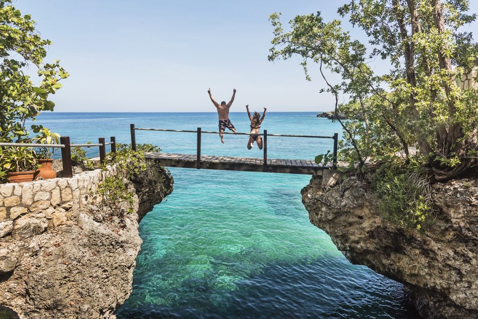 People jumping off bridge in Negril, Jamaica
