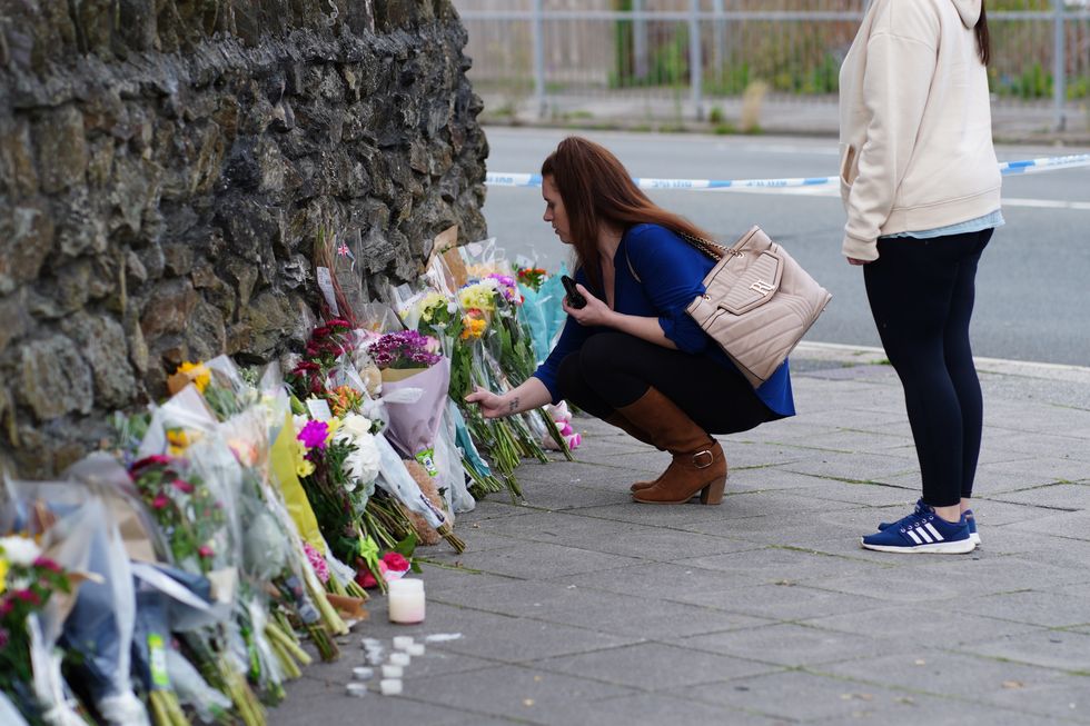 People leave flowers in the Keyham area of Plymouth where six people, including the offender, died of gunshot wounds.