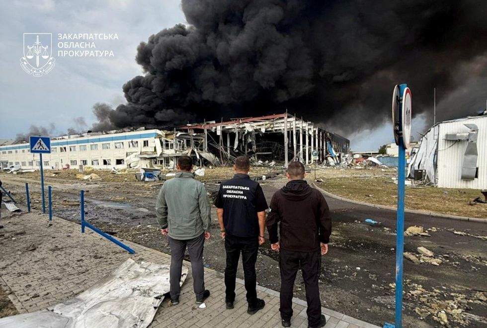 People look on as the US factory burns
