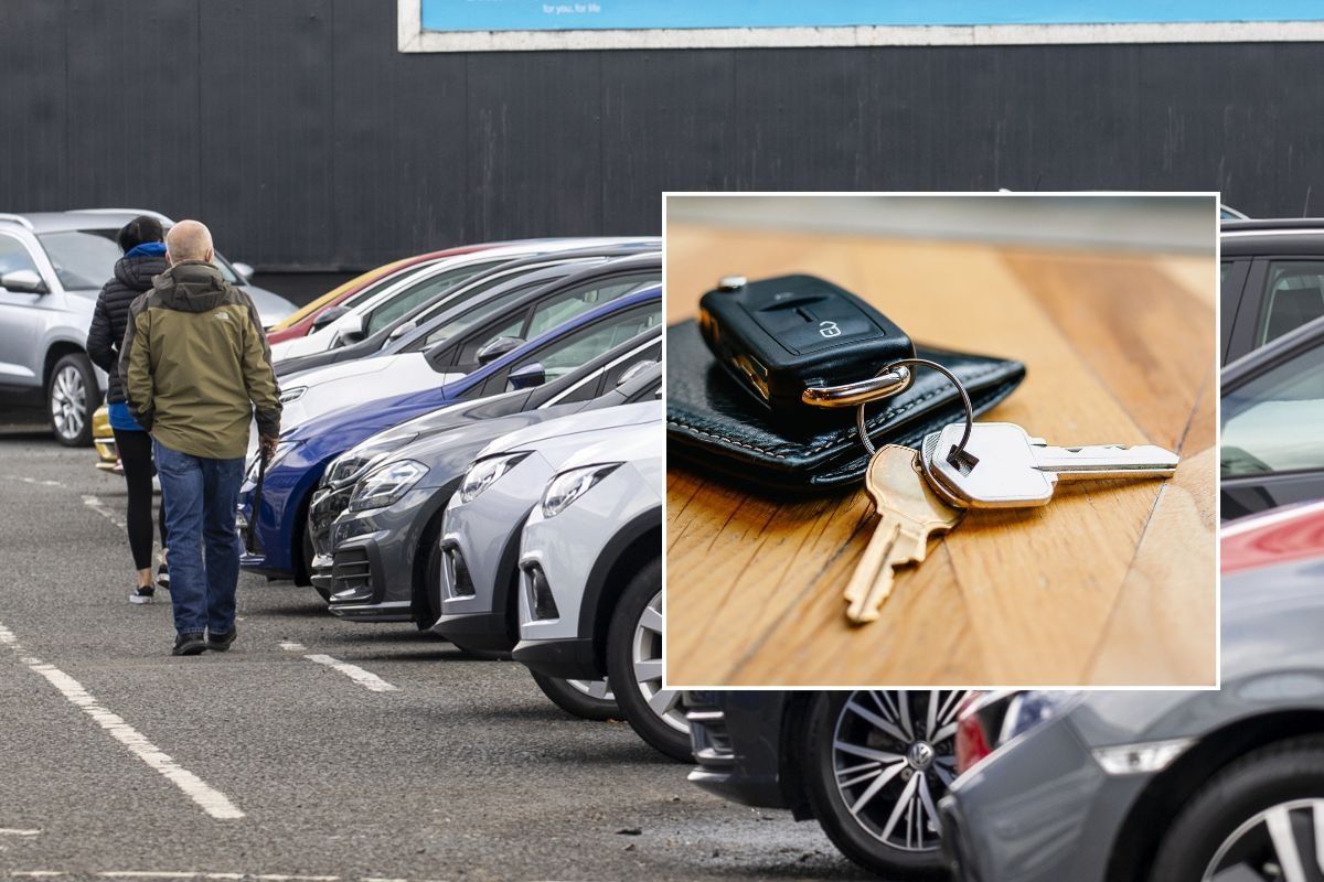 People looking at a car dealership and a set of car keys