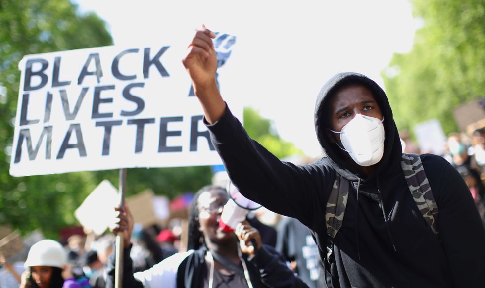 People march in central London after attending a Black Lives Matter rally in Hyde Park, London.