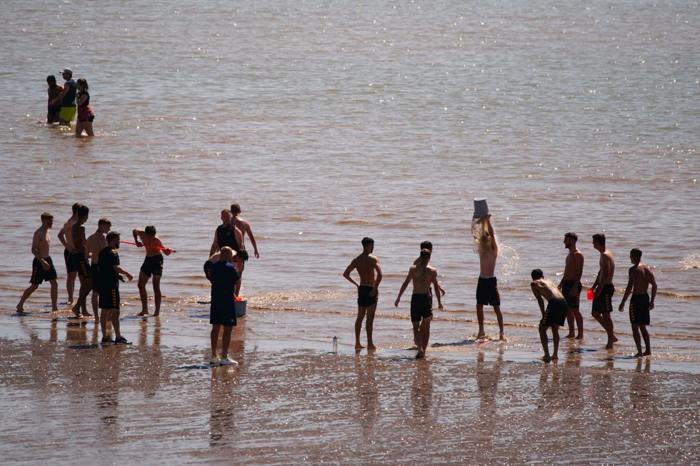 People on the beach at Barry Island, Wales enjoying the hot weather,as Britons are set to sizzle on what could be the hottest day ever recorded in the UK.