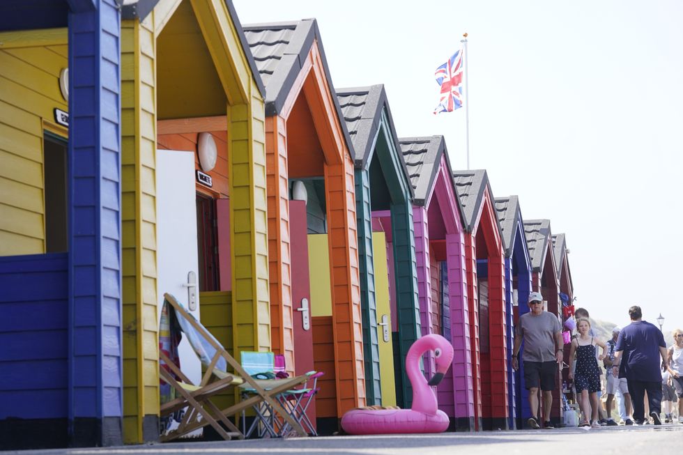 People on the beach at Saltburn-by-the-Sea in North Yorkshire. A heatwave which has baked the UK over the last few days is expected to end with thunderstorms across much of England and Wales this weekend, forecasters have warned. Picture date: Thursday July 22, 2021.
