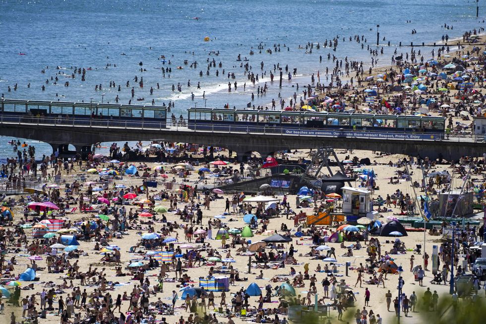 People on the beach in Bournemouth, as the hot weather continues, with forecasters warning of the risk of thundery showers towards the end of the week.