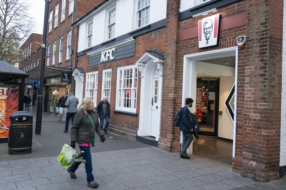 People outside a branch of KFC in Brentwood, Essex which has been linked to a number of cases of the Omicron variant, which have now been confirmed across the country. Picture date: Monday November 29, 2021.