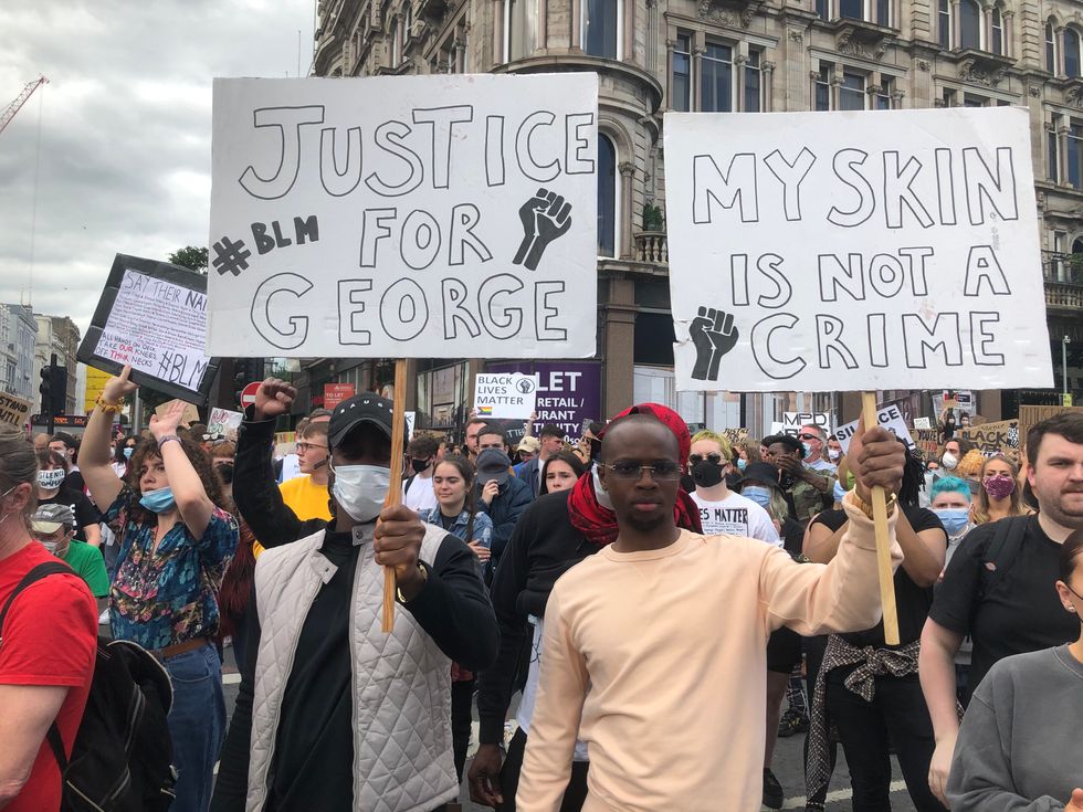 People participate in a Black Lives Matter protest rally march through Donegall Square in Belfast