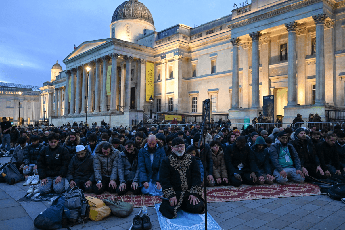 People perform prayers as they attend an 'Open Iftar' event as part of the 'Ramadan Tent Project' in Trafalgar Square