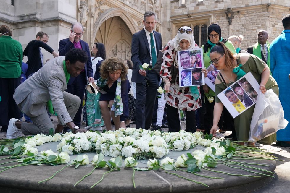 People place white roses in memory of the victims at the Grenfell fire memorial service at Westminster Abbey in London, in remembrance of those who died in the Grenfell Tower fire on June 14 2018. Picture date: Tuesday June 14, 2022.